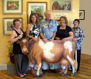 Shown with Jane Yelliott's "Family Zoo" exhibit at In-Town Gallery during the recent opening reception, are family members (left to right ) Susan Batten, Ryan Norris, Finch Yelliott, Shula Yelliott, and Jane Yelliott.